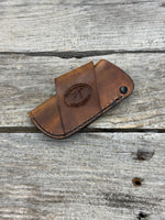 Handmade rustic brown leather knife sheath with black rivet hardware, horizontal carry design for small pocket knives by Cherokee Rose Custom Leather.