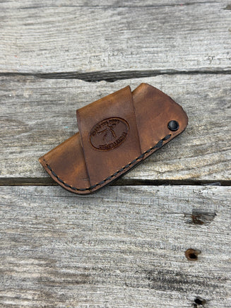 Handmade rustic brown leather knife sheath with black rivet hardware, horizontal carry design for small pocket knives by Cherokee Rose Custom Leather.
