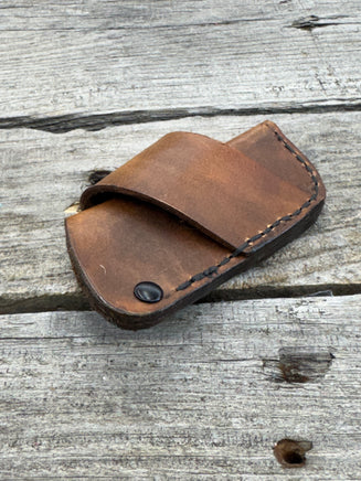 Handmade rustic brown leather knife sheath with black rivet hardware, horizontal carry design for small pocket knives by Cherokee Rose Custom Leather.