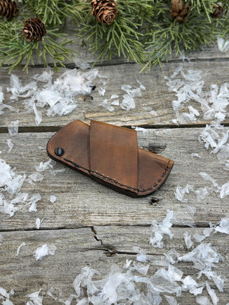 Handmade rustic brown leather knife sheath with black rivet hardware, horizontal carry design for small pocket knives by Cherokee Rose Custom Leather.
