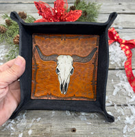 Hand-tooled leather valet tray with carved Texas longhorn skull and barbed wire border, black-dyed leather tray handmade by Cherokee Rose Custom Leather in Texas.