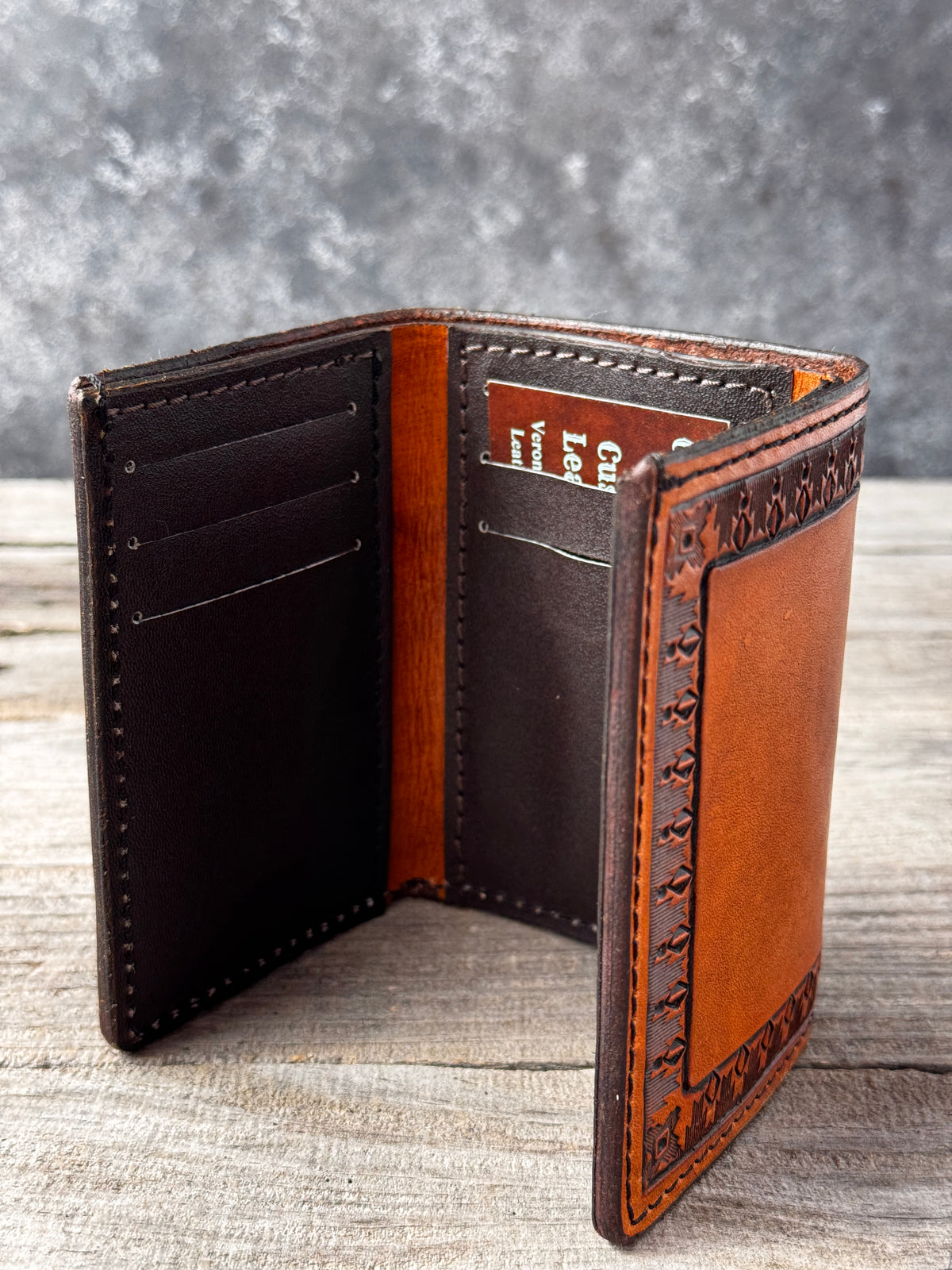 Smooth brown pigskin interior of handmade Western leather trifold wallet