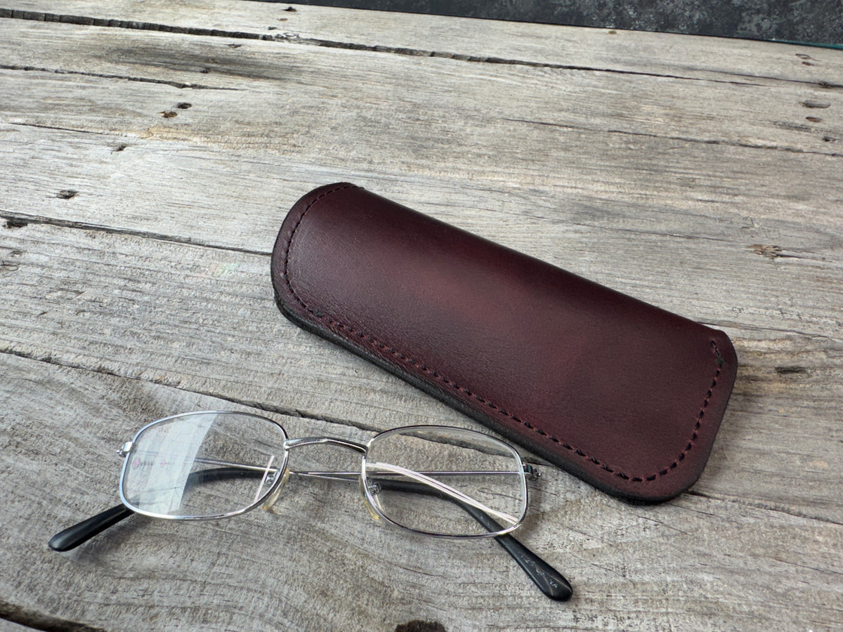 Bayou Red oil tanned leather eyeglass case with eyeglasses for size reference