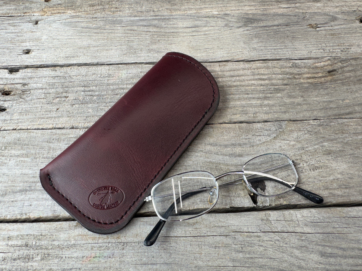 Bayou Red leather eyeglass case with black stitching and eyeglasses