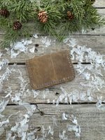 Rustic beige oil-tanned leather card wallet with blue hand stitching, handmade by Cherokee Rose Custom Leather in East Texas.