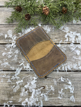 Rustic beige oil-tanned leather card wallet with blue hand stitching, handmade by Cherokee Rose Custom Leather in East Texas.