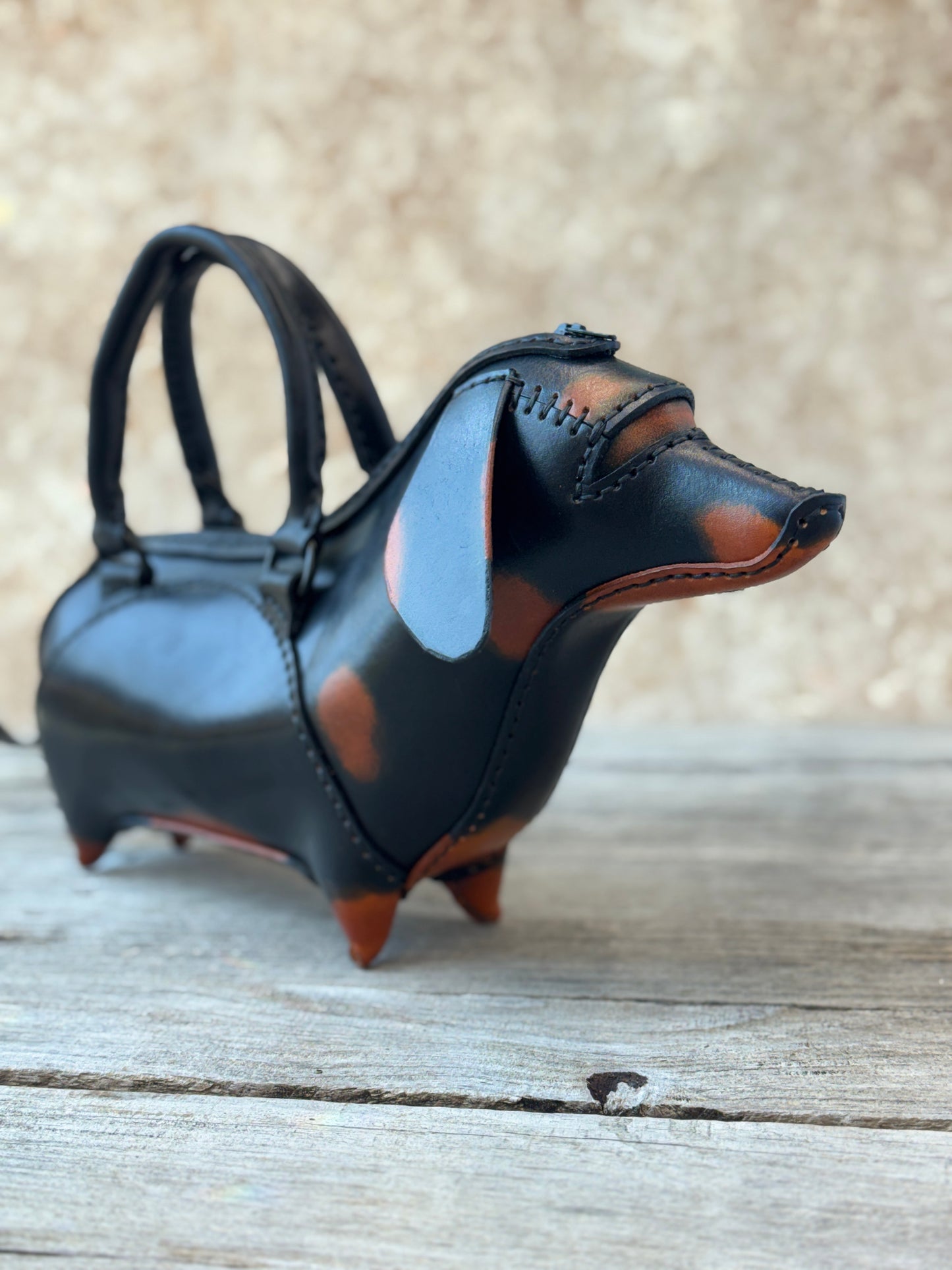 Black and tan leather dachshund handbag showing hand dyed details and hand stitched construction