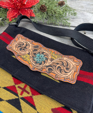 Boho Western messenger bag with hand-tooled sunflower and turquoise scroll leather patch, handmade by Cherokee Rose Custom Leather in East Texas.