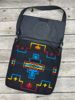 Black woven Southwest messenger bag with hand-tooled leather floral patch and yellow stitching, handmade by Cherokee Rose Custom Leather in East Texas.