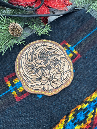 Black woven Southwest messenger bag with hand-tooled leather floral patch and yellow stitching, handmade by Cherokee Rose Custom Leather in East Texas.