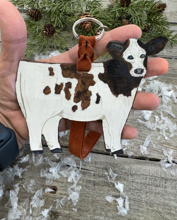Hand-painted brown and white leather show heifer purse hanger with brown pigskin suede strap, handmade by Cherokee Rose Custom Leather in East Texas.