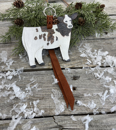 Hand-painted brown and white leather show heifer purse hanger with brown pigskin suede strap, handmade by Cherokee Rose Custom Leather in East Texas.