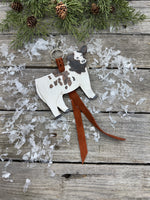 Hand-painted brown and white leather show heifer purse hanger with brown pigskin suede strap, handmade by Cherokee Rose Custom Leather in East Texas.