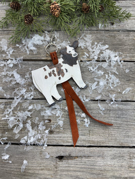 Hand-painted brown and white leather show heifer purse hanger with brown pigskin suede strap, handmade by Cherokee Rose Custom Leather in East Texas.