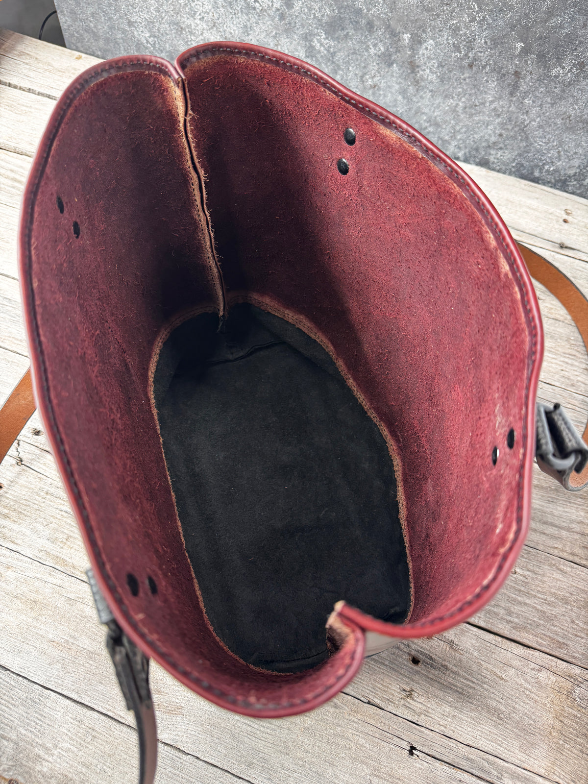 Handcrafted two-tone leather tote with deep burgundy body, black base and long shoulder straps