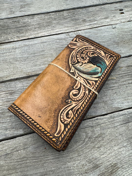 Hand carved leather checkbook cover with floral scrollwork and turquoise feather detail