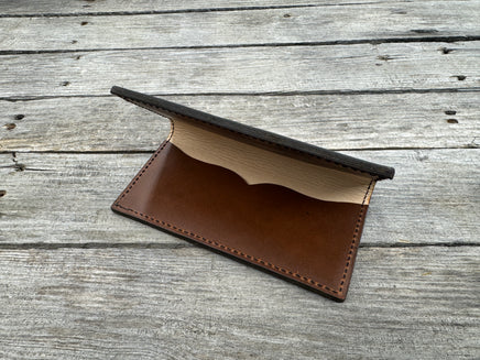 Brown leather wallet on a wooden surface
