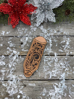 Hand tooled leather cast iron skillet handle cover with floral scroll carving and dyed background, handmade by Cherokee Rose Custom Leather in East Texas.