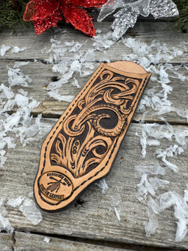Hand tooled leather cast iron skillet handle cover with floral scroll carving and dyed background, handmade by Cherokee Rose Custom Leather in East Texas.