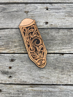 Hand tooled leather cast iron skillet handle cover with floral scroll carving and dyed background, handmade by Cherokee Rose Custom Leather in East Texas.