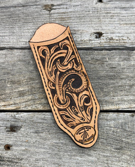 Hand tooled leather cast iron skillet handle cover with floral scroll carving and dyed background, handmade by Cherokee Rose Custom Leather in East Texas.