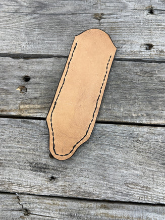 Hand tooled leather cast iron skillet handle cover with floral scroll carving and dyed background, handmade by Cherokee Rose Custom Leather in East Texas.