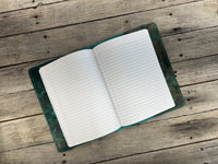 Open notebook on a wooden surface