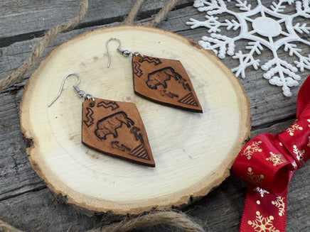Diamond-shaped light tan leather earrings with hand-stamped bison, arrows, and tribal geometric design, handmade by Cherokee Rose Custom Leather in East Texas.