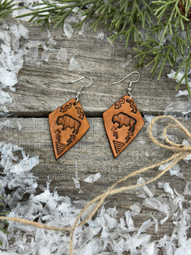 Diamond-shaped light tan leather earrings with hand-stamped bison, arrows, and tribal geometric design, handmade by Cherokee Rose Custom Leather in East Texas.