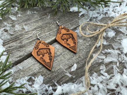 Diamond-shaped light tan leather earrings with hand-stamped bison, arrows, and tribal geometric design, handmade by Cherokee Rose Custom Leather in East Texas.
