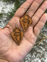 Diamond-shaped light tan leather earrings with hand-stamped bison, arrows, and tribal geometric design, handmade by Cherokee Rose Custom Leather in East Texas.