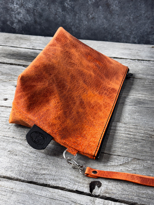 Rustic orange genuine leather zippered makeup bag handcrafted in East Texas