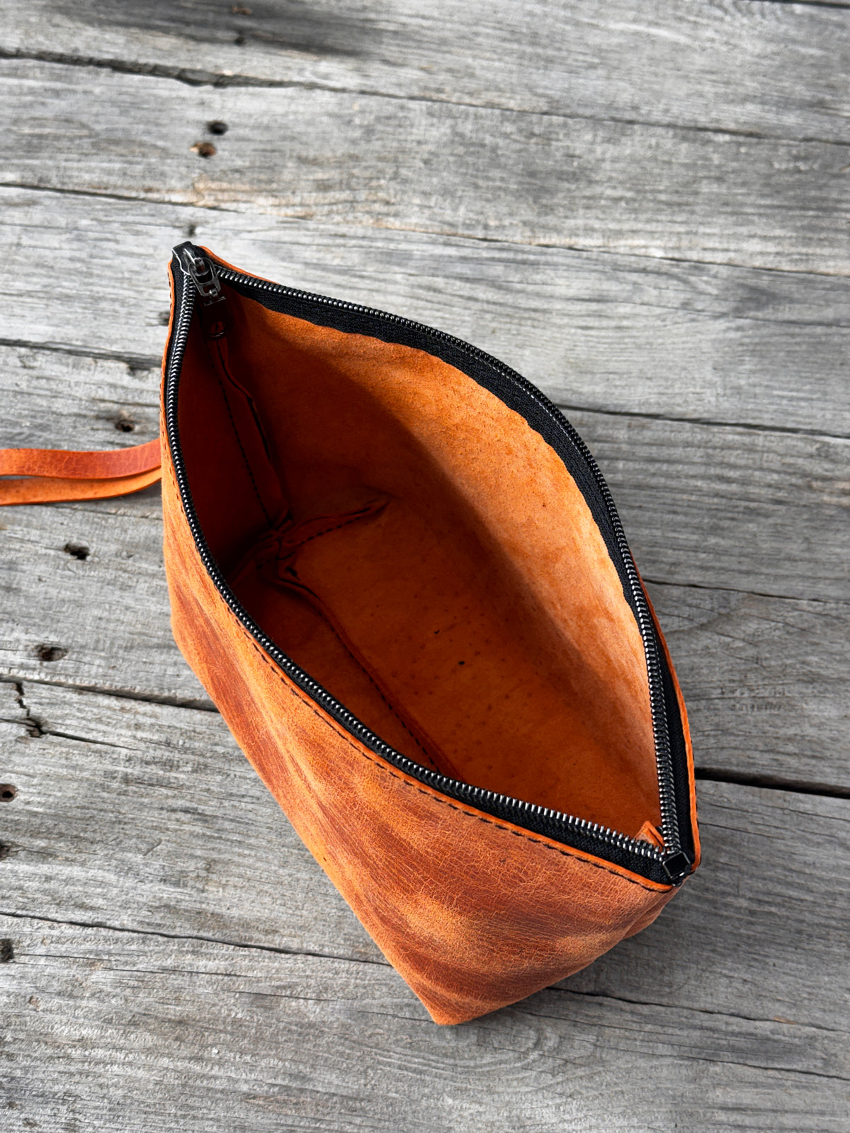 Distressed orange leather cosmetic organizer with structured boxy shape