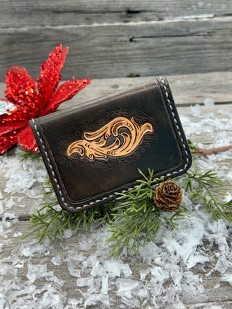 Hand-carved chocolate brown leather card wallet with floral scroll design and gray oil-tanned interior, handmade by Cherokee Rose Custom Leather.