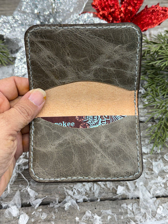 Hand-carved chocolate brown leather card wallet with floral scroll design and gray oil-tanned interior, handmade by Cherokee Rose Custom Leather.