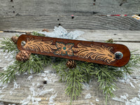 Hand-carved leather cuff bracelet with turquoise flower and floral scrollwork, silver snaps, turquoise suede back, handmade by Cherokee Rose Custom Leather in Texas.