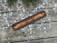 Hand-carved leather cuff bracelet with turquoise flower and floral scrollwork, silver snaps, turquoise suede back, handmade by Cherokee Rose Custom Leather in Texas.