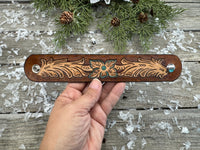 Hand-carved leather cuff bracelet with turquoise flower and floral scrollwork, silver snaps, turquoise suede back, handmade by Cherokee Rose Custom Leather in Texas.