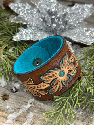 Hand-carved leather cuff bracelet with turquoise flower and floral scrollwork, silver snaps, turquoise suede back, handmade by Cherokee Rose Custom Leather in Texas.