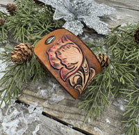 Hand-carved leather cuff bracelet with pink flower accent, gunmetal snaps, and brown suede lining, handmade by Cherokee Rose Custom Leather in Texas.