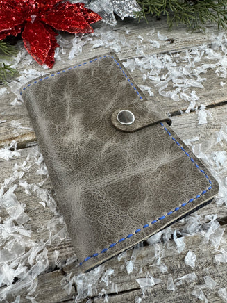 Handmade grey oil-tanned leather memo pad holder with black pigskin interior, royal blue stitching, and silver snap closure by Cherokee Rose Custom Leather.