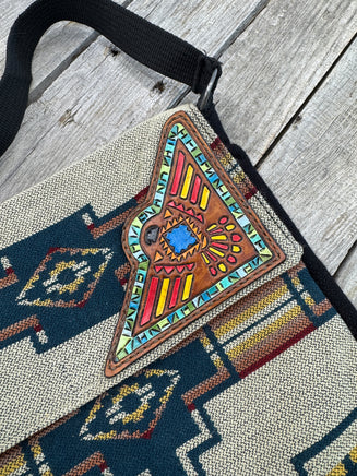 Southwest woven messenger bag with hand-painted leather Thunderbird patch, handmade by Cherokee Rose Custom Leather in East Texas.