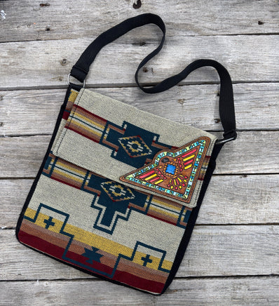Southwest woven messenger bag with hand-painted leather Thunderbird patch, handmade by Cherokee Rose Custom Leather in East Texas.