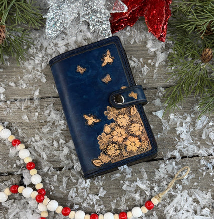 Hand stamped blue leather memo pad holder with bees, butterflies, and flowers, handmade by Cherokee Rose Custom Leather in East Texas.