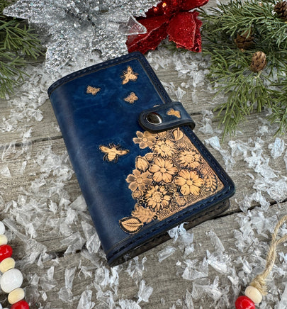 Hand stamped blue leather memo pad holder with bees, butterflies, and flowers, handmade by Cherokee Rose Custom Leather in East Texas.