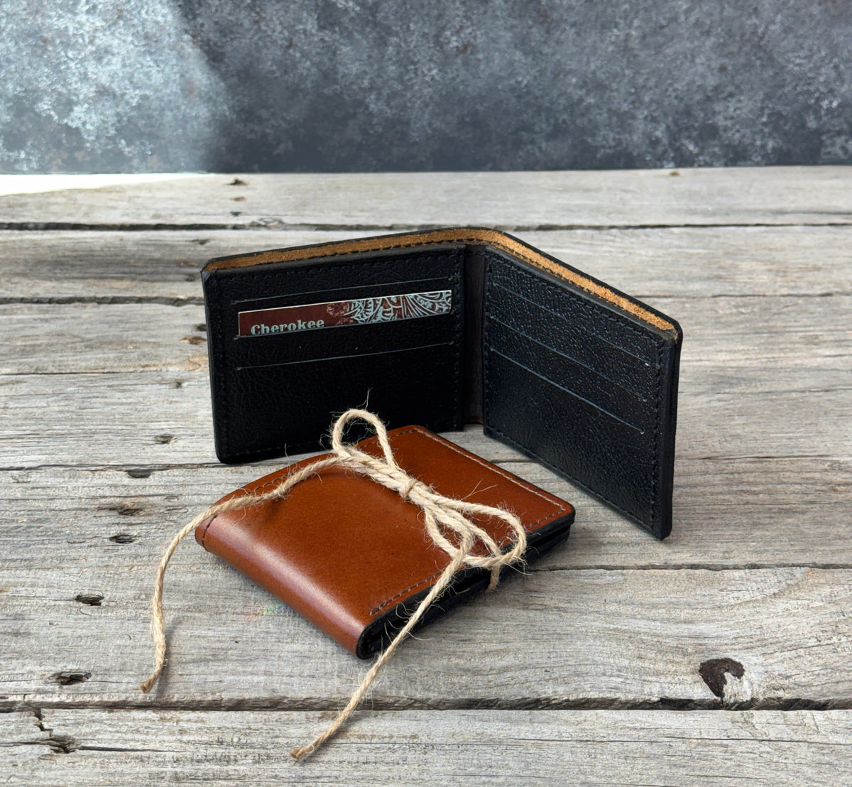 Two handmade oil tanned leather bifold wallets in Rodeo Tan and Dark Brown