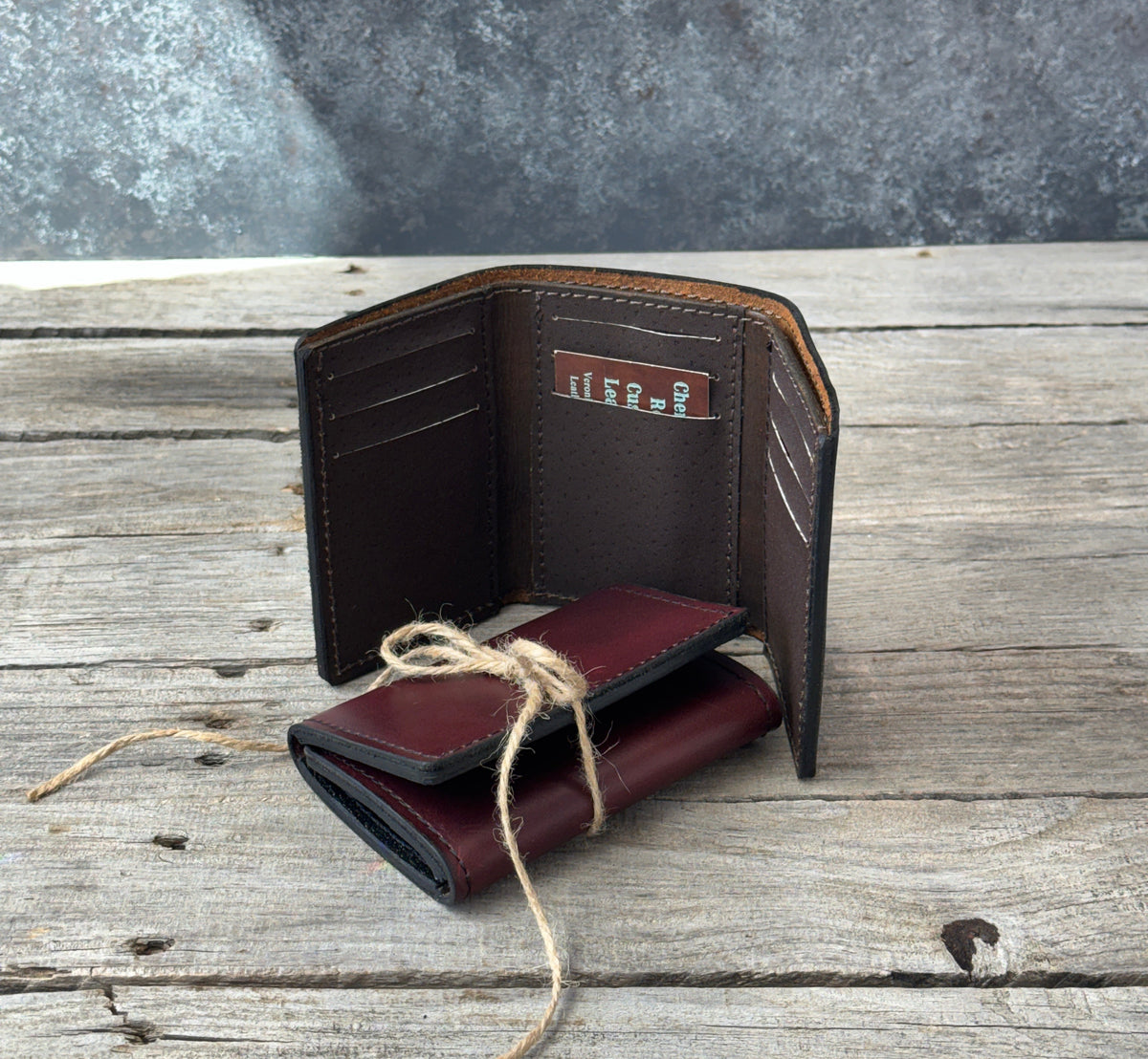 Two handmade oil tanned leather trifold wallets in Bayou Red Brown and Rustic Brown