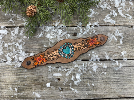 Hand-carved leather cuff bracelet with turquoise heart, orange flowers, and antique copper snaps, handmade by Cherokee Rose Custom Leather in East Texas.