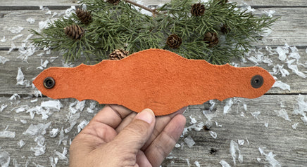 Hand-carved leather cuff bracelet with turquoise heart, orange flowers, and antique copper snaps, handmade by Cherokee Rose Custom Leather in East Texas.