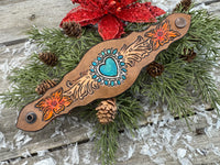 Hand-carved leather cuff bracelet with turquoise heart, orange flowers, and antique copper snaps, handmade by Cherokee Rose Custom Leather in East Texas.